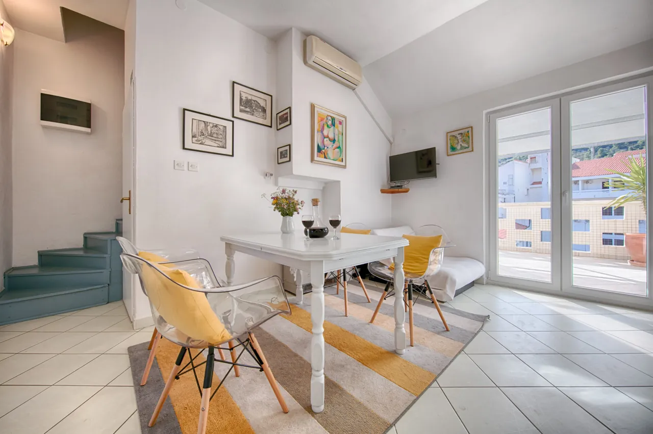 Dining table, staircase and glass doors, Nono Andre apartment, Komiža
